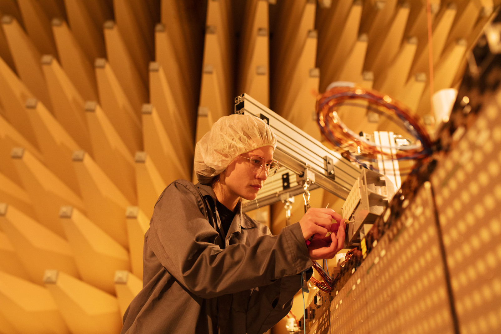 Female ICEYE employee working on satellite